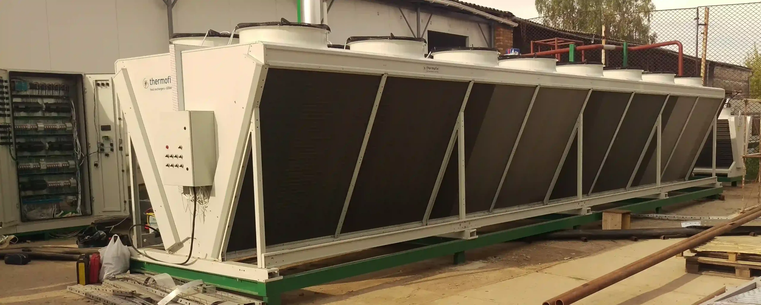  Industrial chiller installation on a building rooftop by HVAC technicians.